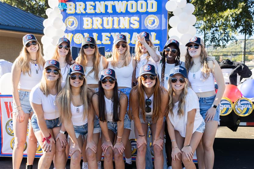 Students ride on a homecoming parade float